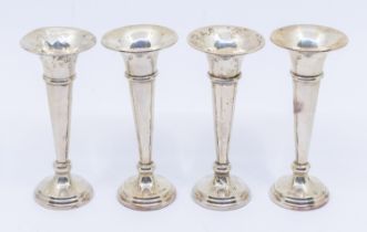 A matched set of four George V silver posy vases, filled, hallmarked Birmingham, various makers,