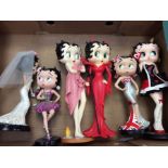 A collection of six Betty Boop figures between 25cm and 30cm high.