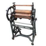 A vintage cast iron mangle, pioneer GC.354, painted in black with wooden rollers.