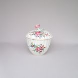 An eighteenth century Worcester porcelain sucrier and cover with a flower head finial decorated with