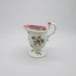 A Liverpool Seth Pennington polychrome cream jug, decorated with floral sprays, with a Biting