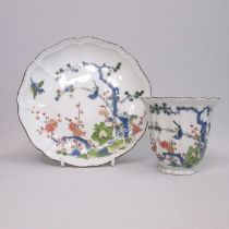 A rare Meissen fluted octagonal beaker and saucer, painted with the ‘Three Friends of Winter’