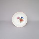 A Rare Worcester Saucer with a fluted body, painted with a flower spray, London decorated,