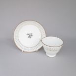 A porcelain white and gilt tall tea bowl and saucer, possibly Derby, marked with a Sevres style mark