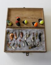 A collection of two dozen early / mid 20th century fishing spinners and lures, together with six