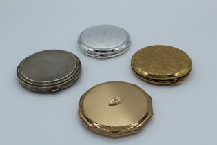 Collection of stratton compacts featuring a silver compact plus three gold tone examples