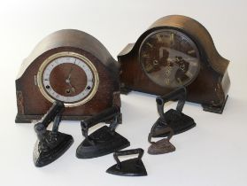 Two 1930's mantle clocks together with four flat irons, the largest 13cm