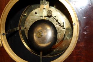 John Walker, London, an Edwardian mahogany, fan inlaid and strung library clock. The lancet form