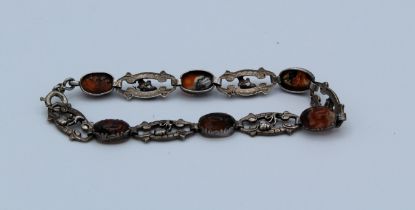 An Arts and Crafts bracelet on unmarked metal set with six moss agate caboches, approximate length