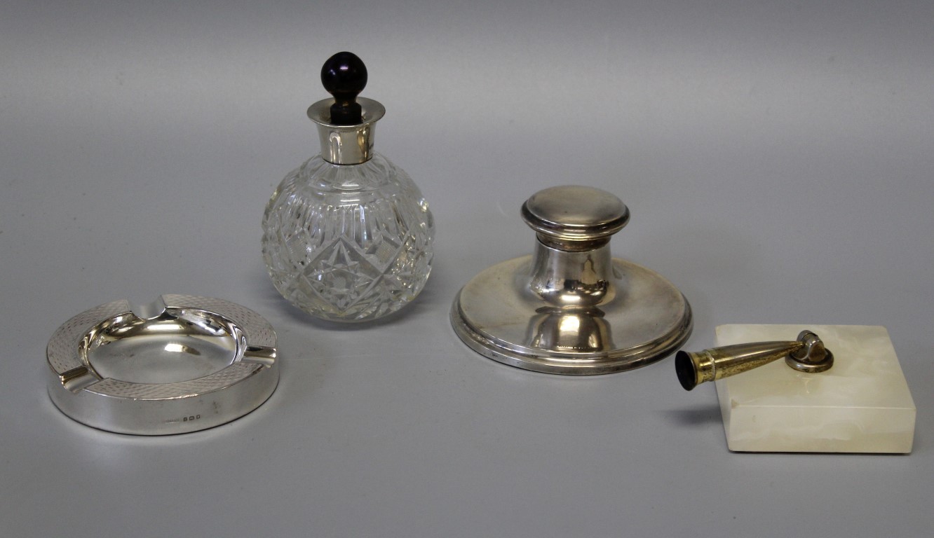 A selection of desktop items comprising a silver collared cut glass scent bottle, Chester