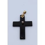 A diamond set mourning cross with yellow metal mounting diamond. Diamond is an old mine cut with a