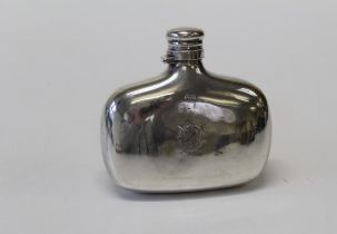 A Victorian silver hip flask with bayonet cap and engraved crest, London 1882