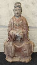 A large Chinese polychrome painted plaster figure of Guanyin, early 20th century. Seated with