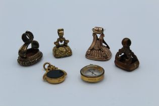 A collection of watch fobs, featuring a rose yellow metal Georgian example, set with a carnelian (