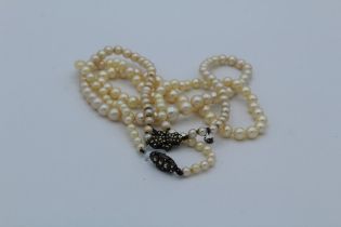 Two graduated single row cultured pearl necklaces, each with marcasite set clasp