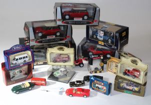 A collection of approximately two dozen Burago, Matchbox and other vehicles, largely boxed