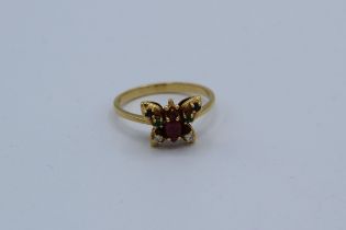 An 18k butterfly ring set emeralds, sapphires, marquise cut ruby body and two eight cut diamonds