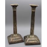 A pair of loaded sterling silver Corinthian column design candlesticks. Marked for Emick Romer,