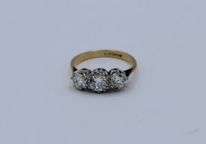 An 18ct three stone diamond ring, total diamond weight approximately 1.10ct