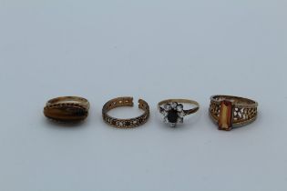 Four various dress rings, stamped 9ct including tigers eye
