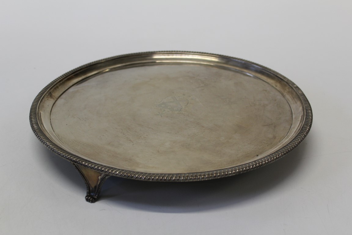 A sterling silver footed salver, marked London with armorial crest. Approximate weight 1,120gm