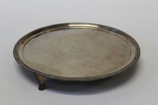 A sterling silver footed salver, marked London with armorial crest. Approximate weight 1,120gm