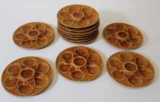 A set of twelve 20th century Longchamp majolica oyster plates, each caramel glazed with shell and