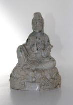A 20th century Chinese carved quartz / bowenite figure of Guanyin. Typically modelled seated upon an