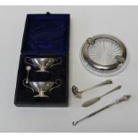 A cased, matched pair of silver navette form twin handled salts, a presentation silver mounted