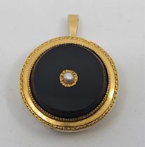 A 19th century precious yellow metal, onyx and pearl circular pendant/brooch, set single pearl to
