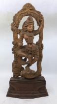 An Indian carved wooden figure of a deity. H:50cm