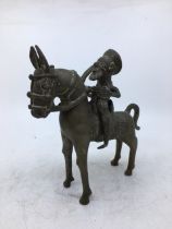 An Indian bronze figure of a man on a horse. H:19cm