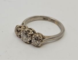 An 18ct. white gold and platinum three stone diamond ring, set three graduated round brilliant cut