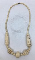 A carved bone necklace.