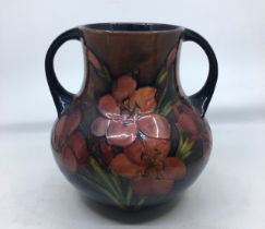 A William Moorcroft twin handled vase, impressed and painted factory marks, height 20.7cm. Condition