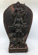 A Sino-Tibetan carved wooden figural group. H:40cm