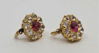 A pair of precious yellow metal, clear stone and ruby cluster earrings, each set mixed round cut