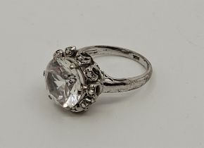 A white metal and clear topaz dress ring, set single mixed round cut clear topaz to centre, size