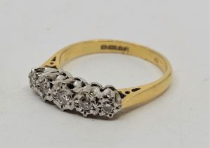 An 18ct. gold five stone diamond ring, Illusion set five graduated round brilliant cut diamonds (