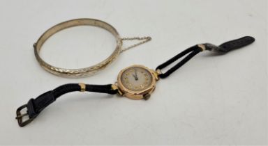 A 9ct. gold ladies' wrist watch, manual movement, having engine turned circular dial with Arabic