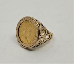 An Elizabeth II 1982 half sovereign gold coin, mounted in a 9ct. gold ring (as found). (gross weight