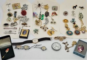 A quantity of costume jewellery brooches, together with gilt metal watches etc. (qty)