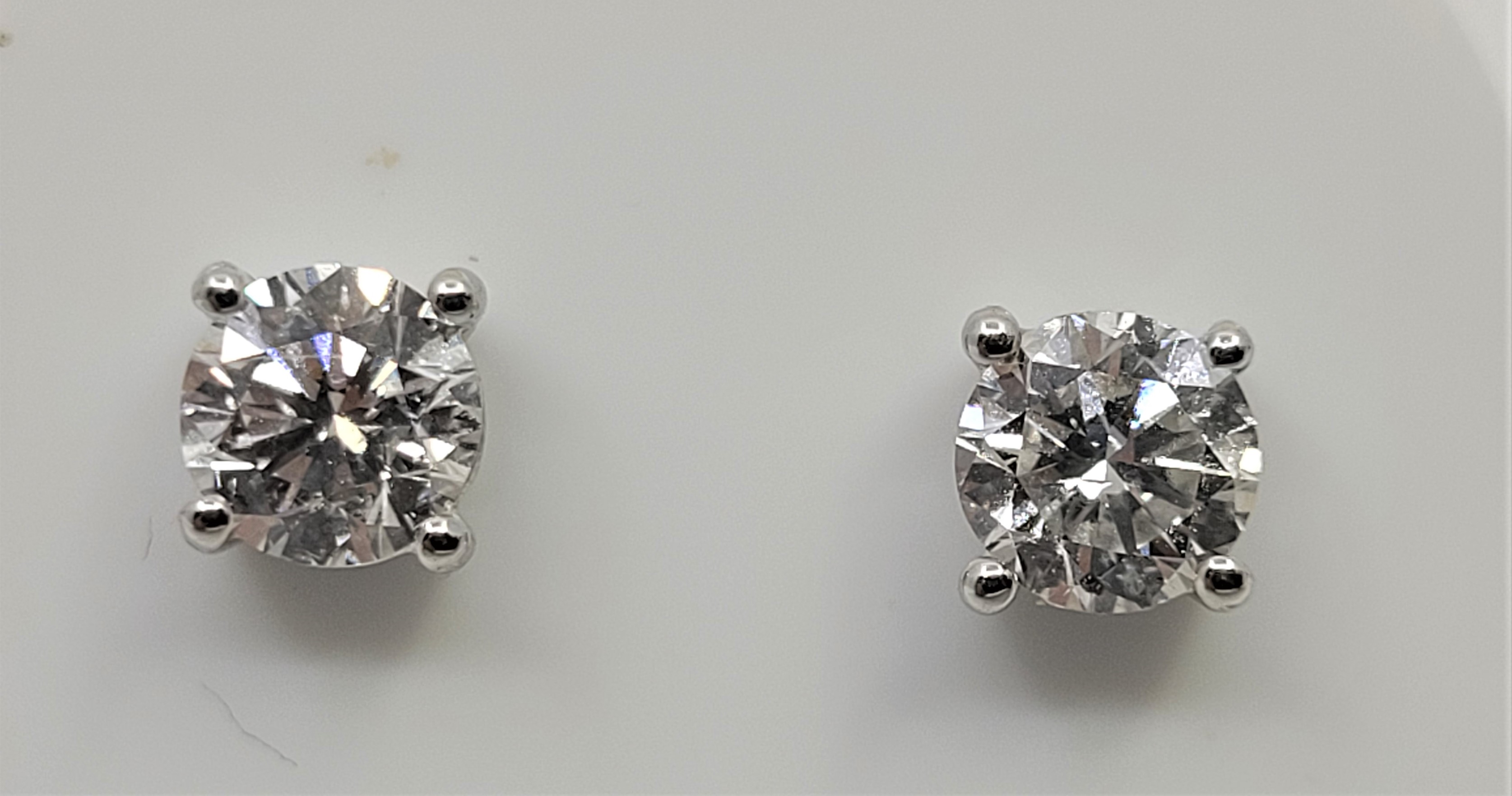 A pair of 18ct. white gold diamond stud earrings, each set single round-brilliant cut diamond of - Image 2 of 3