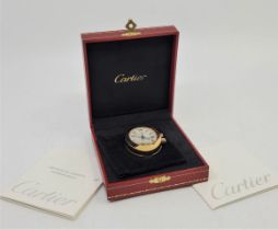 A Cartier gold plated desktop or nightstand oval quartz 2752 travel alarm clock, c.2006, having