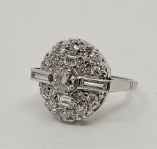 An 18ct white gold diamond cluster ring, having oval domed mount set round brilliant cut diamond