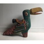 A novelty child's carved wooden chair fashioned as a parrot polychrome painted. H:64cm L:91cm