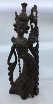 An Asian carved wooden figure of a deity. H:52cm