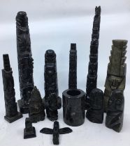 A collection of twelve carved wooden/stone figures. H:34cm (tallest) (some a/f)