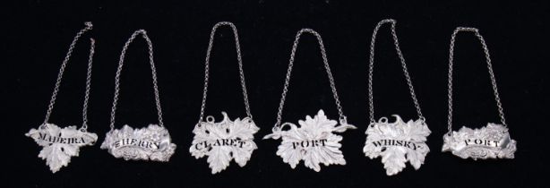 Four Victorian silver vine leaf shaped bottle labels to include: WHISKEY, MADEIRA, PORT, CLARET, all