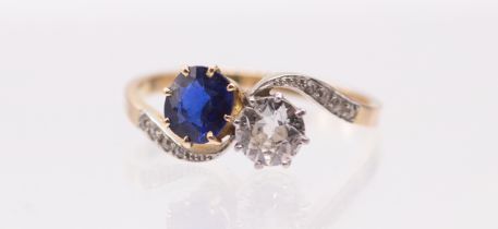 A diamond and sapphire Toi et Moi 18ct gold ring, comprising an old European cut diamond, weighing